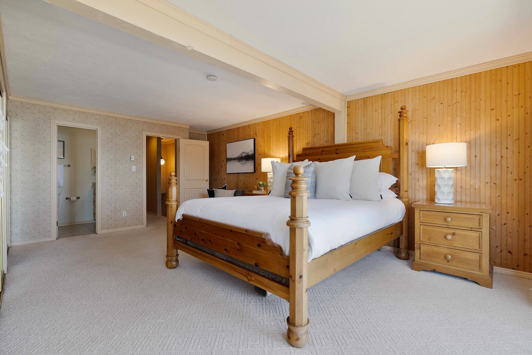 Primary bedroom with pine bed and ensuite access