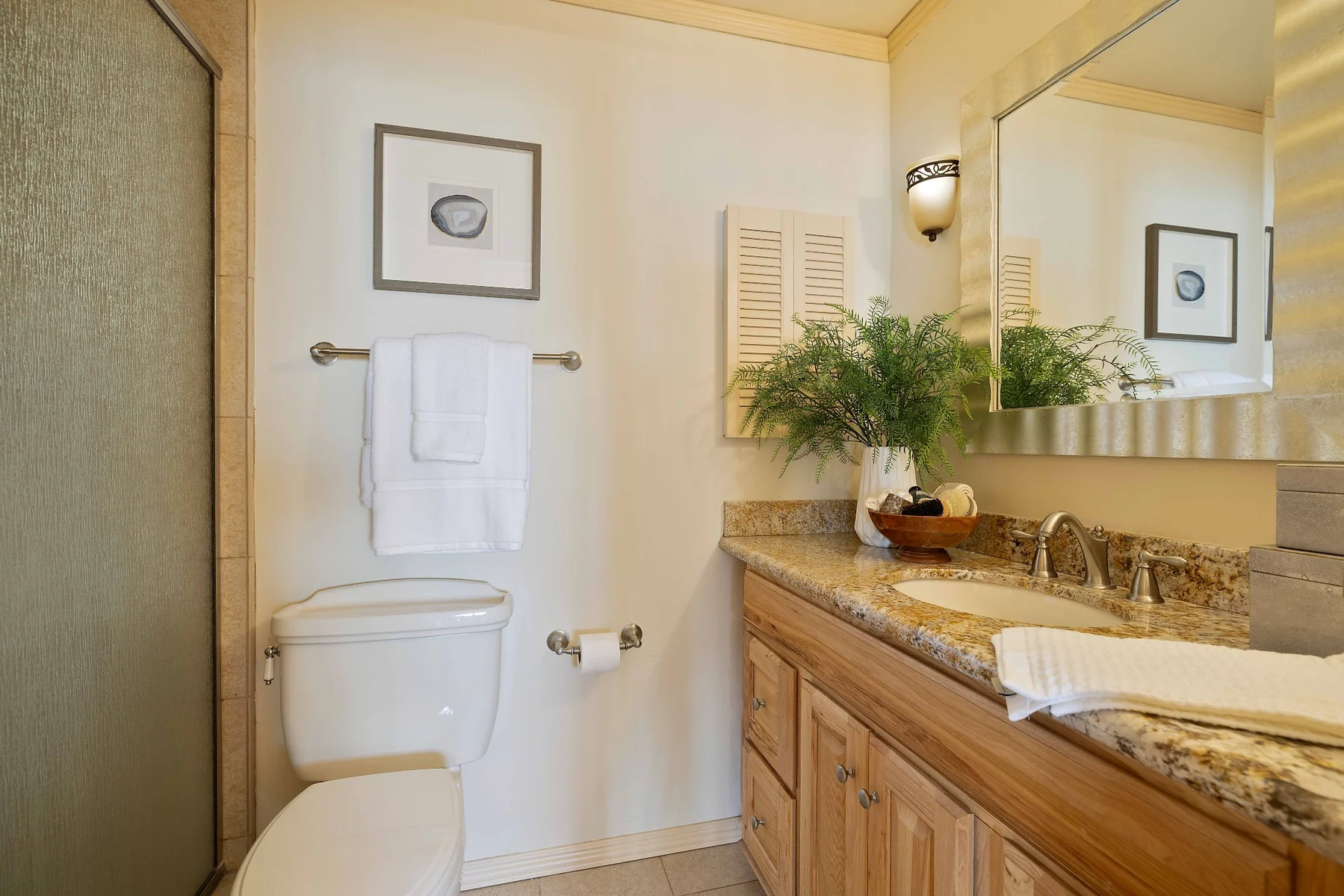 Primary bathroom with granite vanity and shower