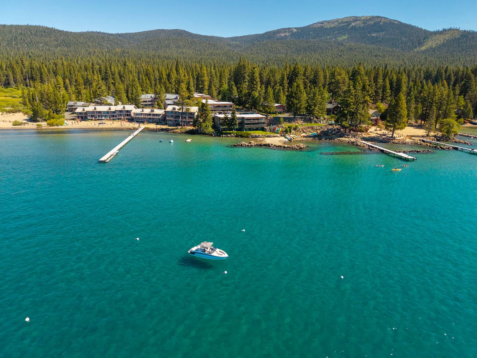 Wide Lake Tahoe aerial with boat and shoreline community
