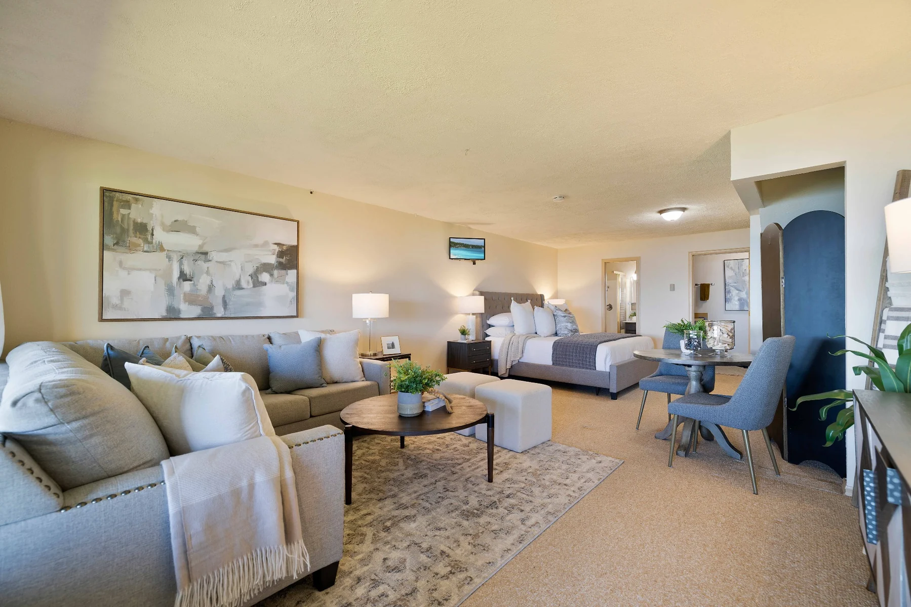 Lower-level living and sleeping area with kitchenette nearby