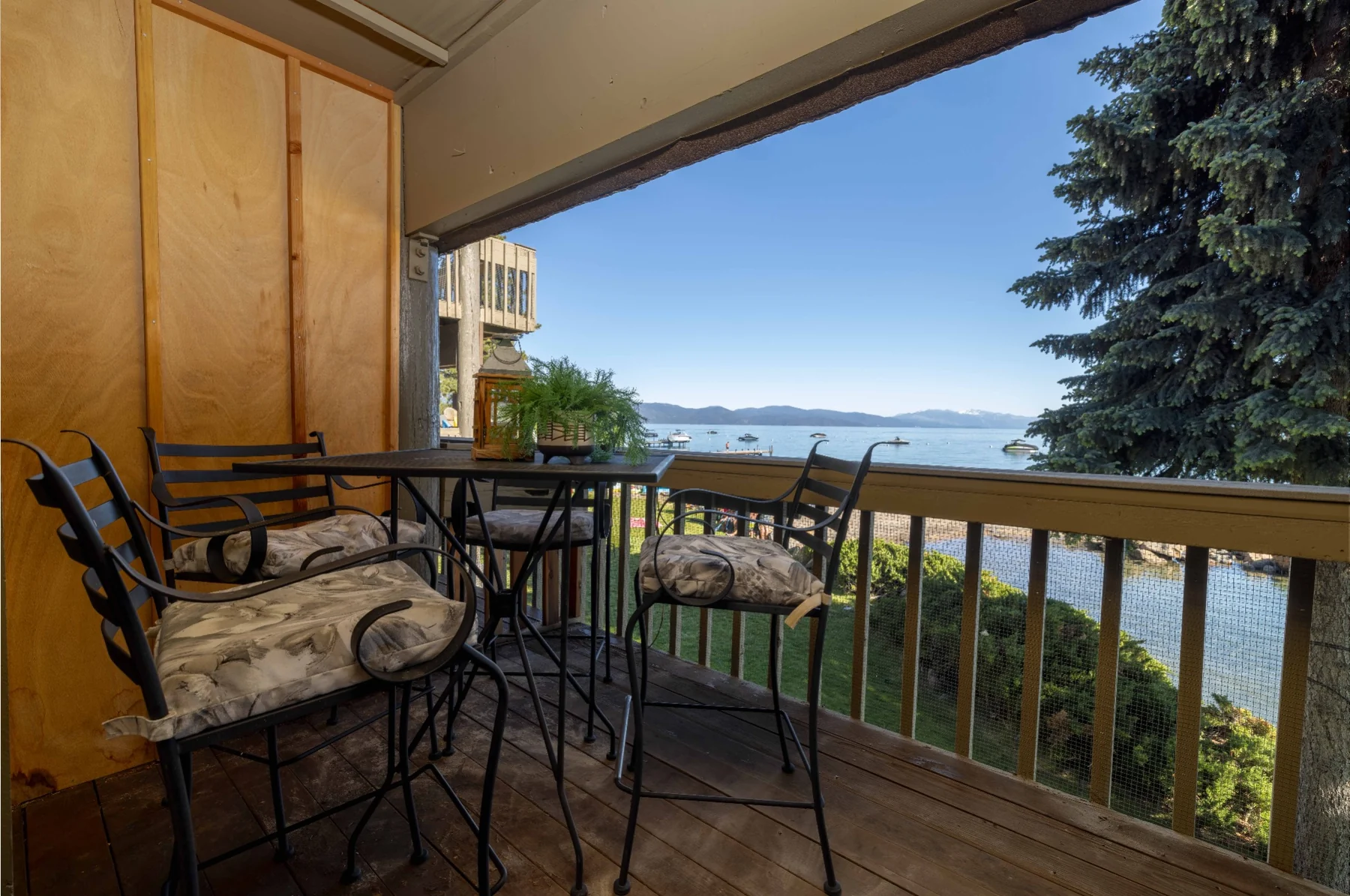 Covered balcony seating with panoramic lake views