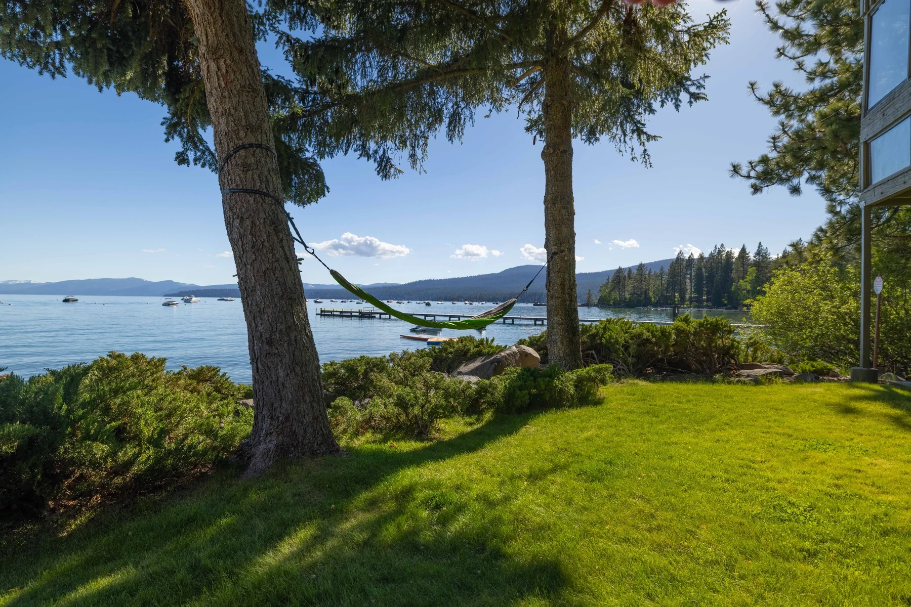 Lakefront lawn with hammock between trees